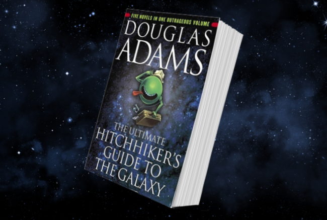 The front of The Ultimate Hitchiker's Guide to the Galaxy book in front of stars and the Milky Way.
